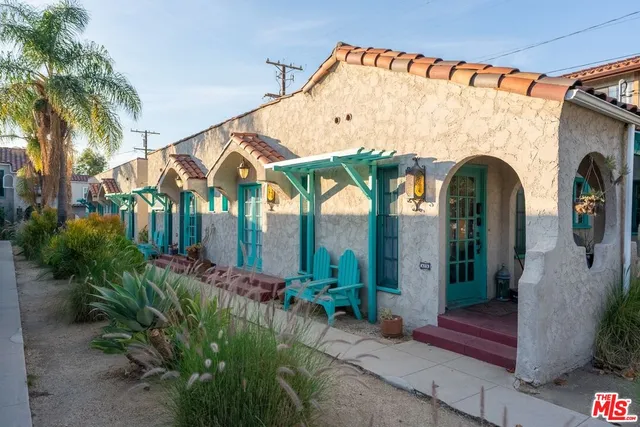 a view of small house with potted plants