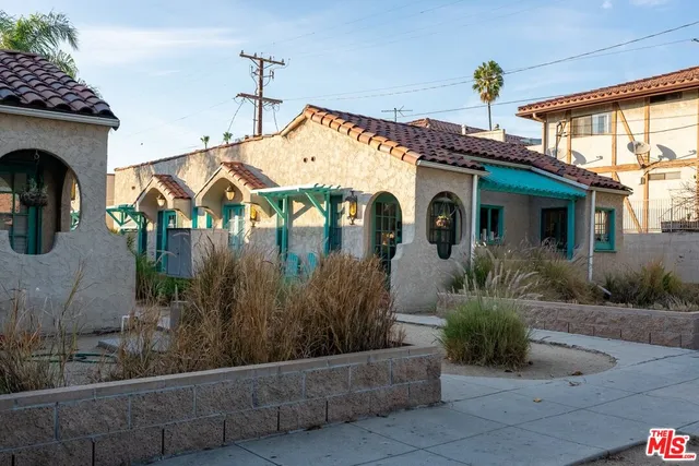 a front view of a house with garden