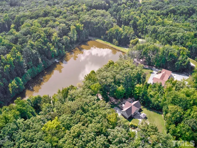 an aerial view of residential house with outdoor space and lake view