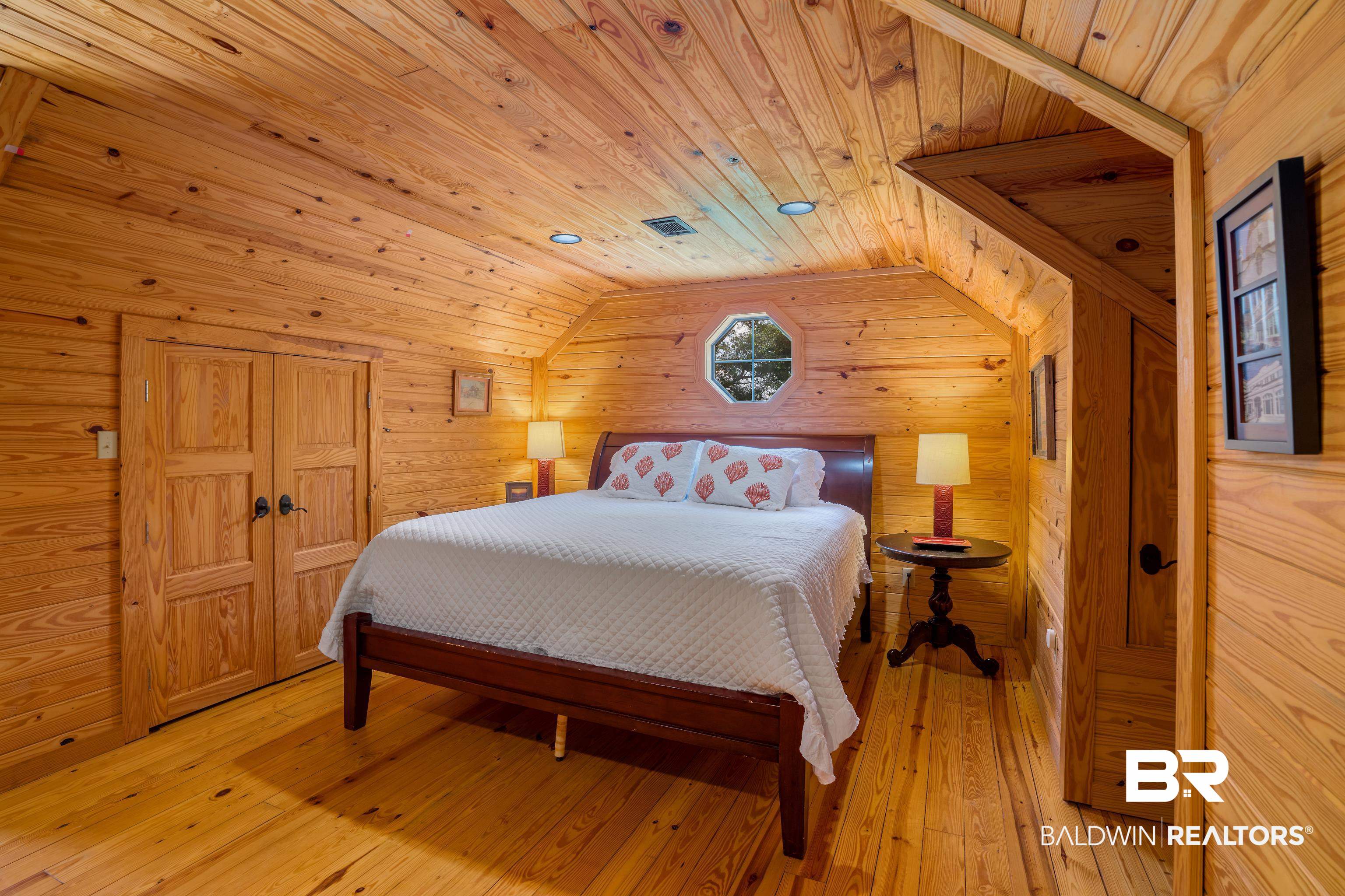 13253 Mary Ann Bch Road Fairhope, AL 36532 - Photo 31 of 54 Bedroom featuring wooden walls, light hardwood / wood-style floors, vaulted ceiling, and wood ceiling