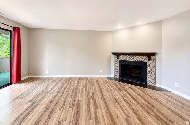 6907 South 745th Street East, Unit G Midvale, UT 84047 - Photo 3 of 30 Spacious main living area with fireplace and balcony access