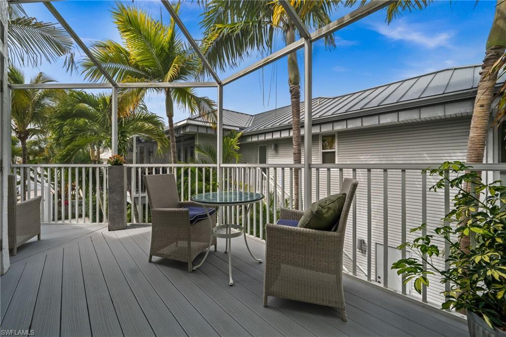 361 2nd Street South Naples, FL 34102 - Photo 12 of 31 a view of a chair and table on the deck