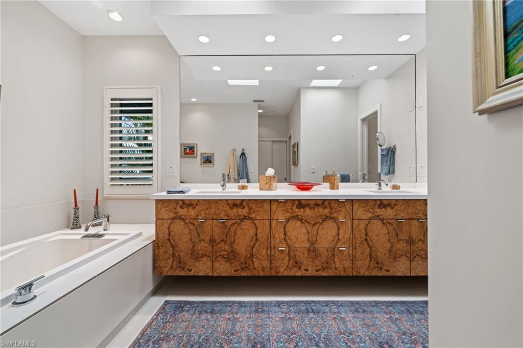 361 2nd Street South Naples, FL 34102 - Photo 16 of 31 a bathroom with a double vanity sink mirror and bathtub