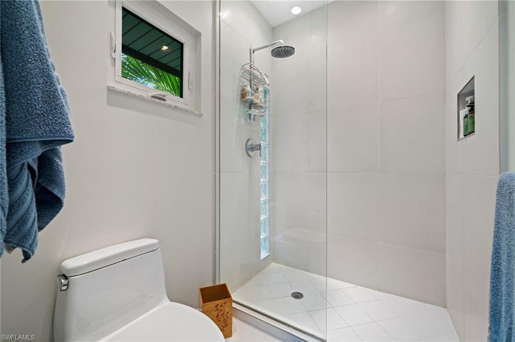 361 2nd Street South Naples, FL 34102 - Photo 22 of 31 a bathroom with a shower a toilet and a sink