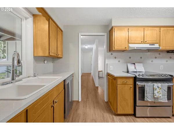 a kitchen with stainless steel appliances a refrigerator and a stove