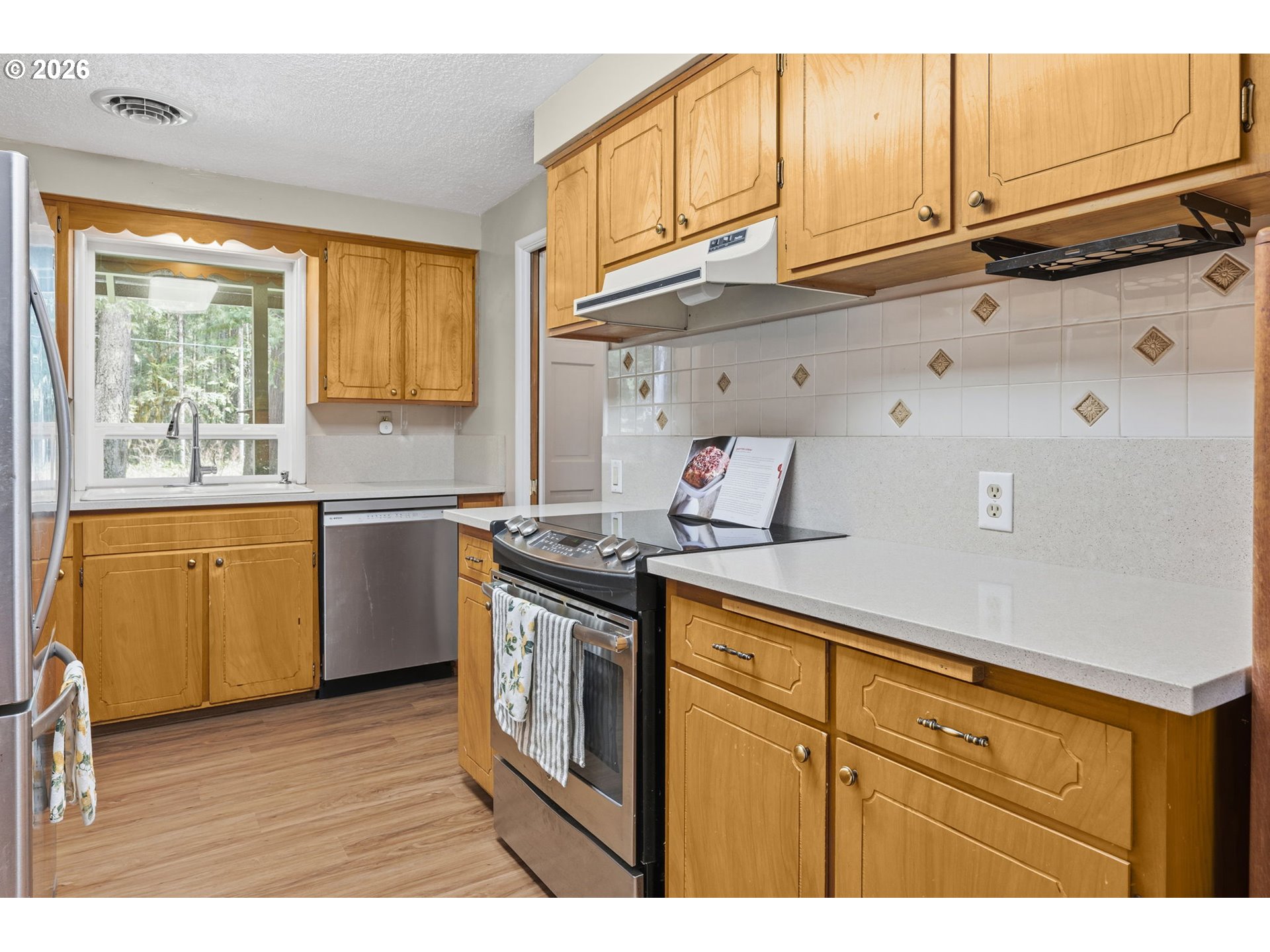 91638 Horse Creek Road Blue River, OR 97413 - Photo 13 of 47 a kitchen with stainless steel appliances granite countertop a sink a stove cabinets and wooden floor