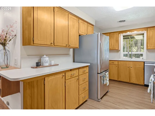 a kitchen with a refrigerator and a sink