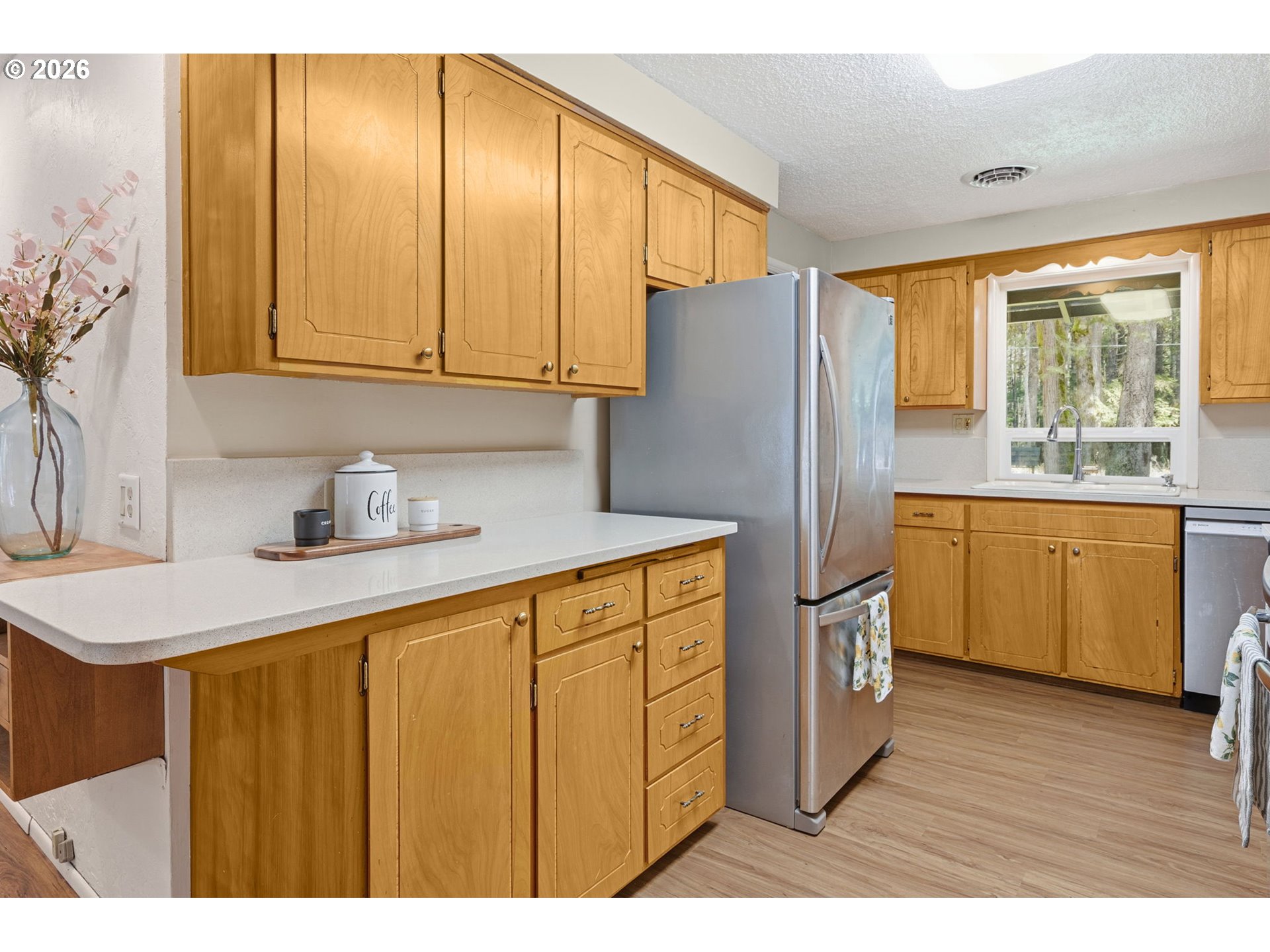 91638 Horse Creek Road Blue River, OR 97413 - Photo 15 of 47 a kitchen with stainless steel appliances granite countertop a refrigerator a sink dishwasher and wooden cabinets with wooden floor