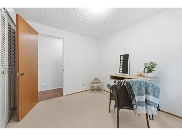 a bedroom with a bed and a night stand