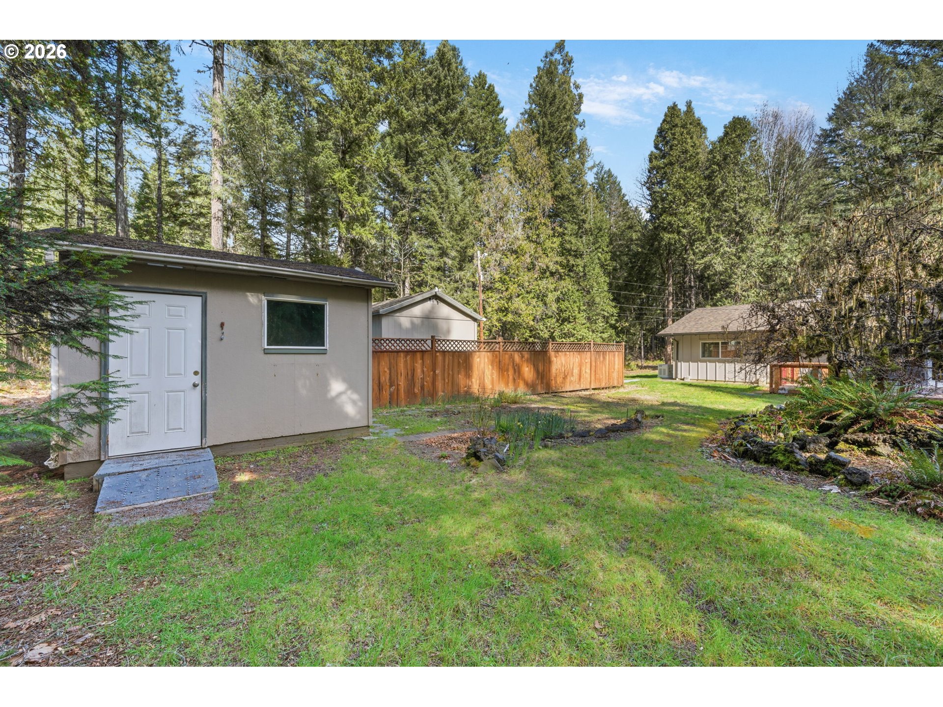 91638 Horse Creek Road Blue River, OR 97413 - Photo 37 of 47 a backyard of a house with table and chairs