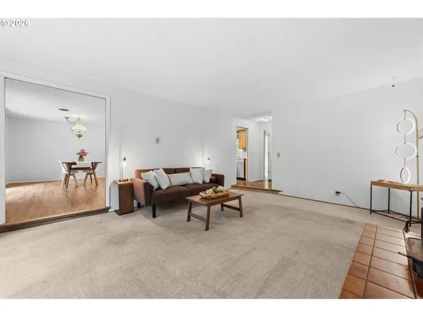 a workspace room with furniture wooden floor and a chandelier