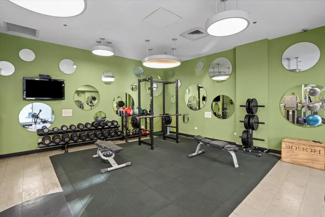 a room with gym equipment and a mirror