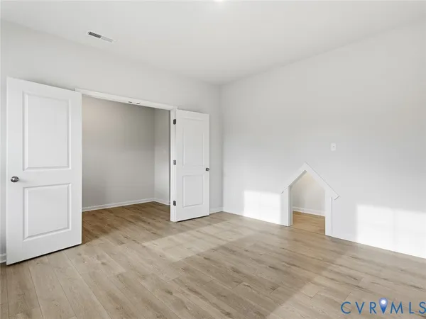 a view of an empty room and wooden floor