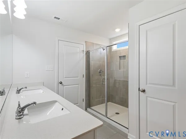 a bathroom with a shower sink and mirror