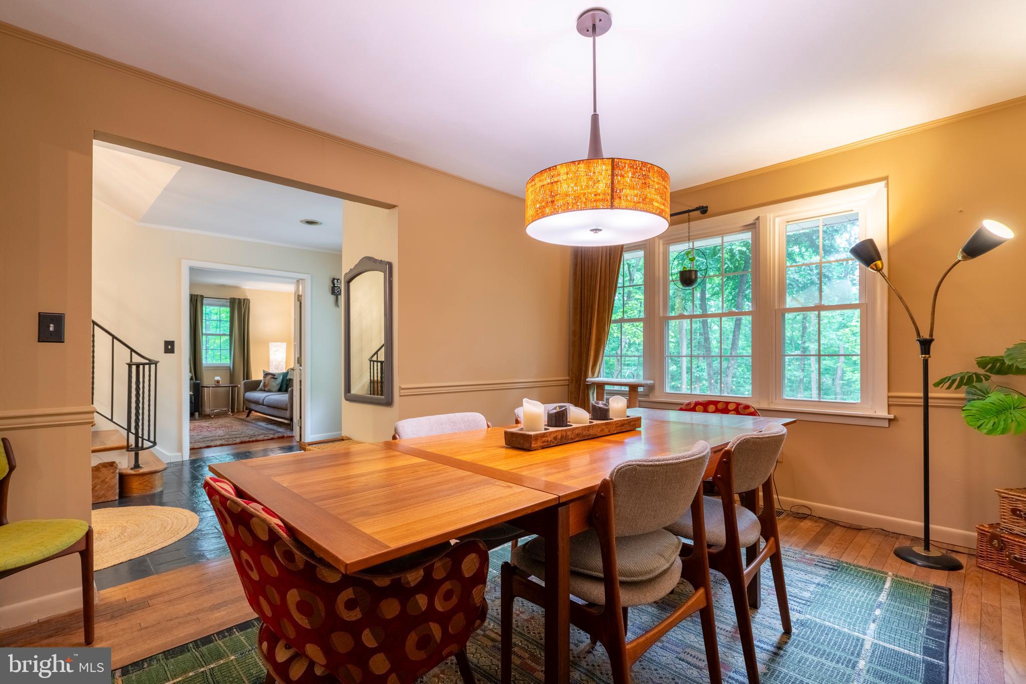 284 Whites Mill Road Green Lane, PA 18054 - Photo 16 of 54 a dining room with wooden floor a chandelier a wooden table and chairs