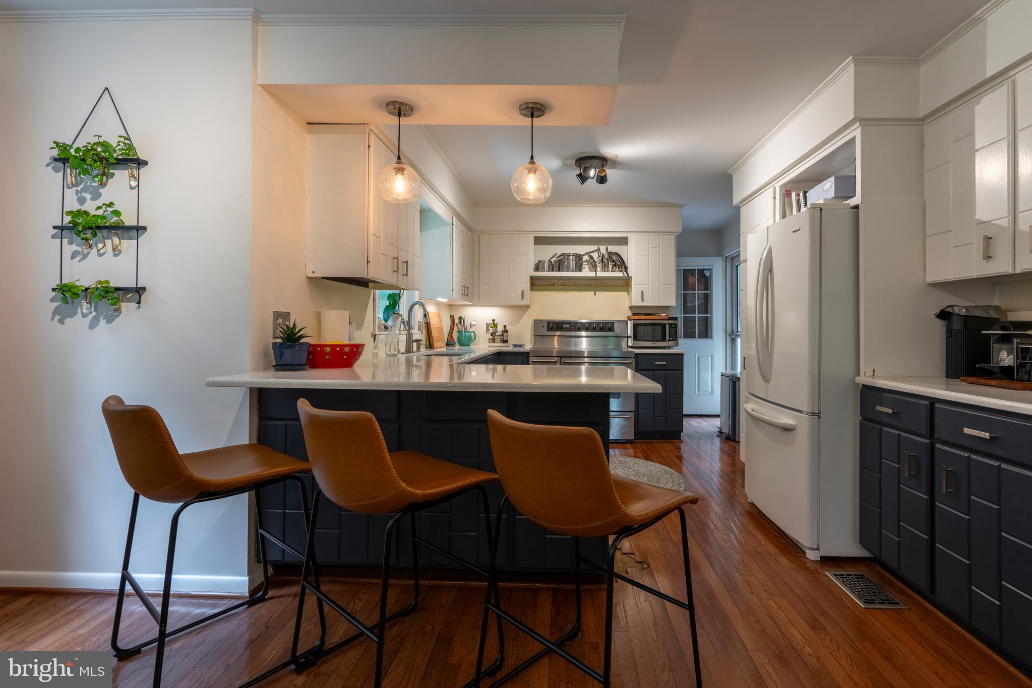 284 Whites Mill Road Green Lane, PA 18054 - Photo 19 of 54 a kitchen with stainless steel appliances a dining table chairs refrigerator and sink