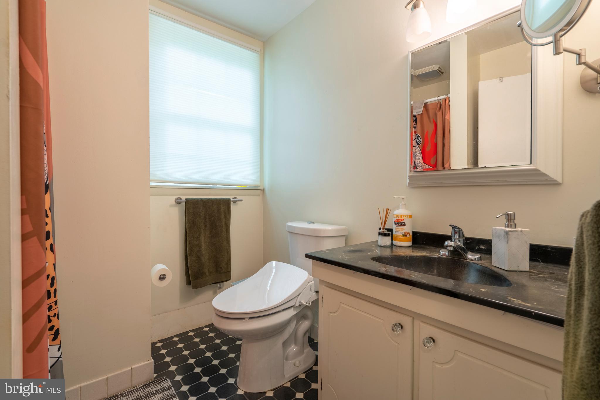 284 Whites Mill Road Green Lane, PA 18054 - Photo 38 of 54 a bathroom with a granite countertop toilet sink and mirror