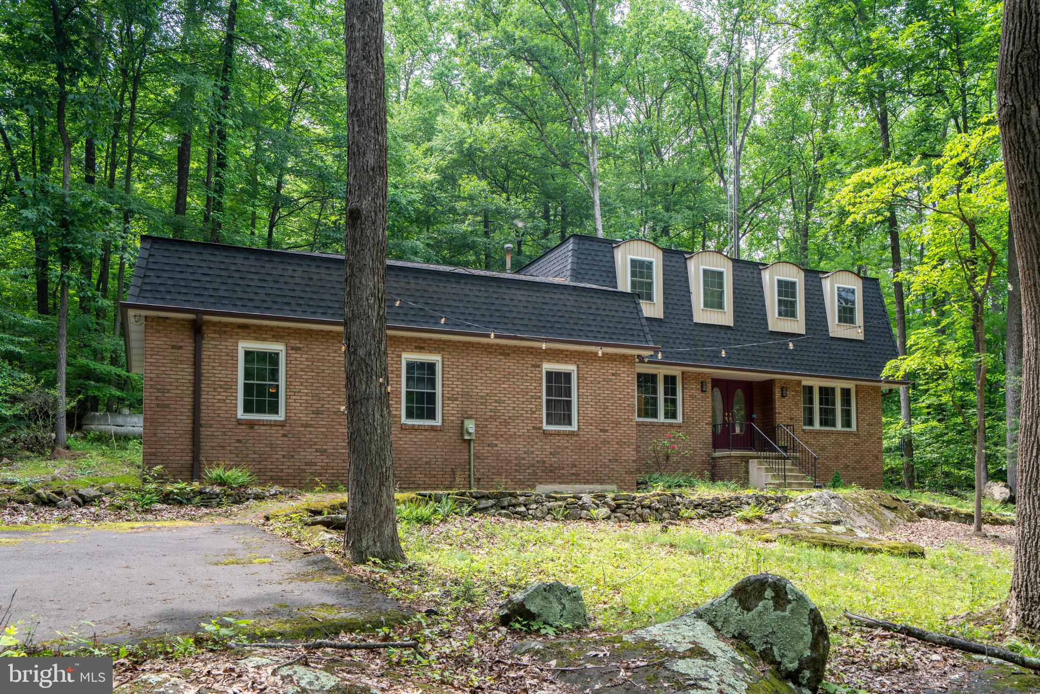 284 Whites Mill Road Green Lane, PA 18054 - Photo 4 of 54 a brick house with a yard plants and large tree