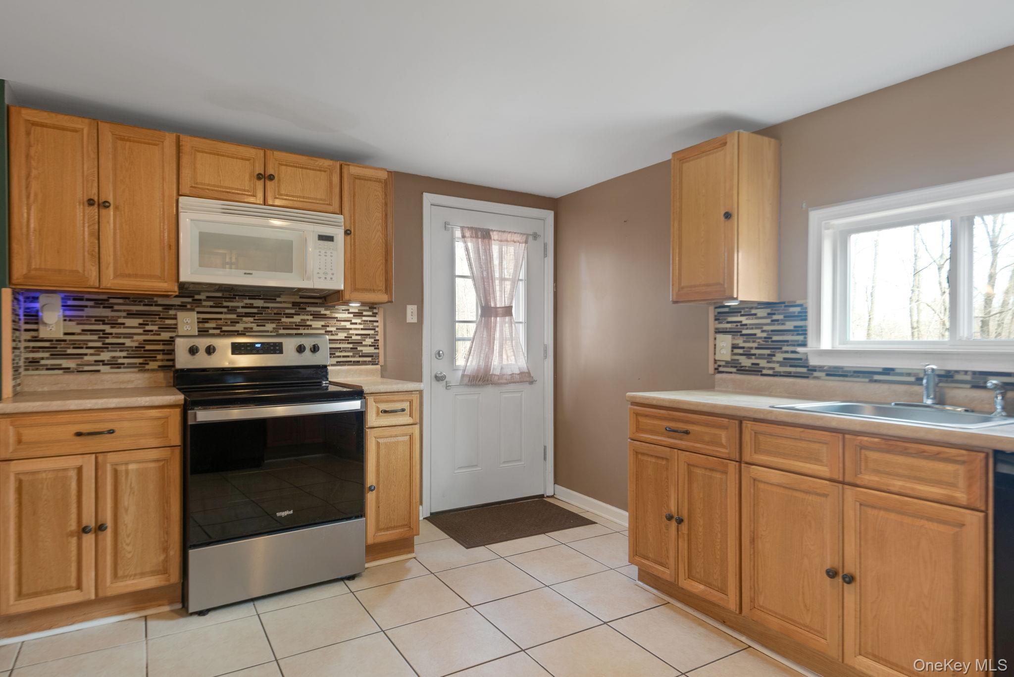 37 Pressler Road Wallkill, NY 12589 - Photo 11 of 25 a kitchen with granite countertop a stove sink and cabinets