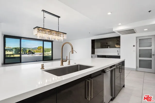 a kitchen with stainless steel appliances a sink and a stove
