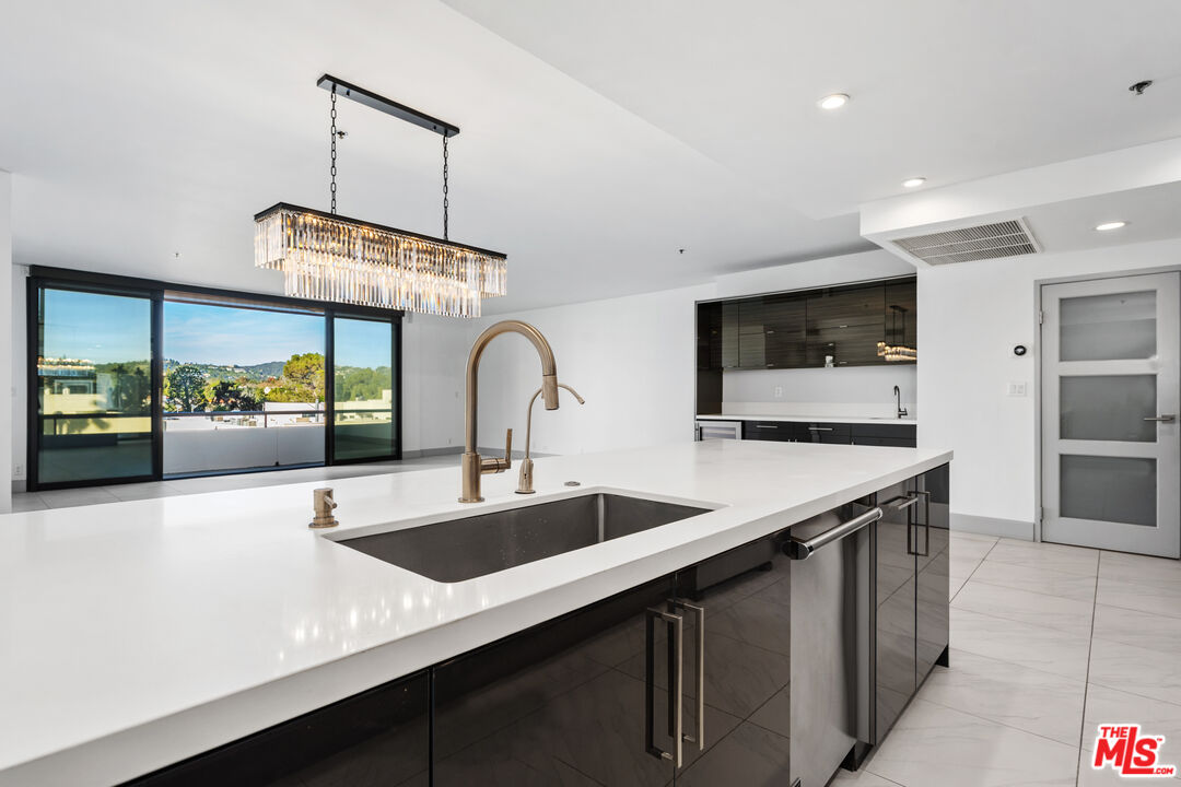 a kitchen with stainless steel appliances a sink and a stove