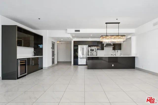a kitchen with stainless steel appliances a sink and a refrigerator