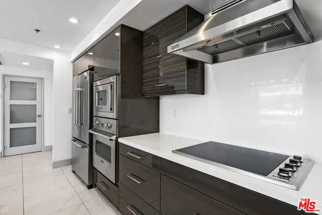 a kitchen with stainless steel appliances a refrigerator sink and microwave