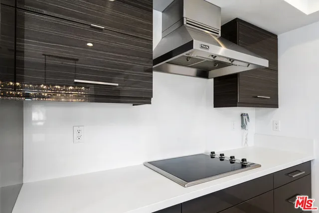 a kitchen with a refrigerator and a stove