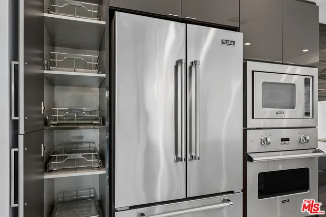 a view of an empty room with a fireplace and window