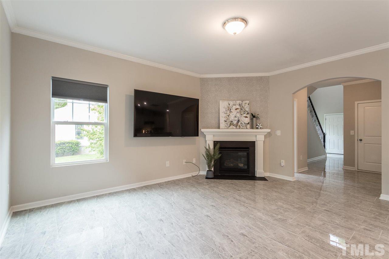 835 Davidson Point Road Cary, NC 27513 - Photo 11 of 30 an empty room with windows and fireplace
