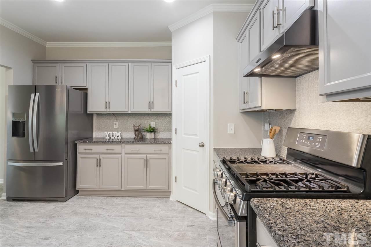 835 Davidson Point Road Cary, NC 27513 - Photo 14 of 30 a kitchen with stainless steel appliances granite countertop a stove a refrigerator and a stove