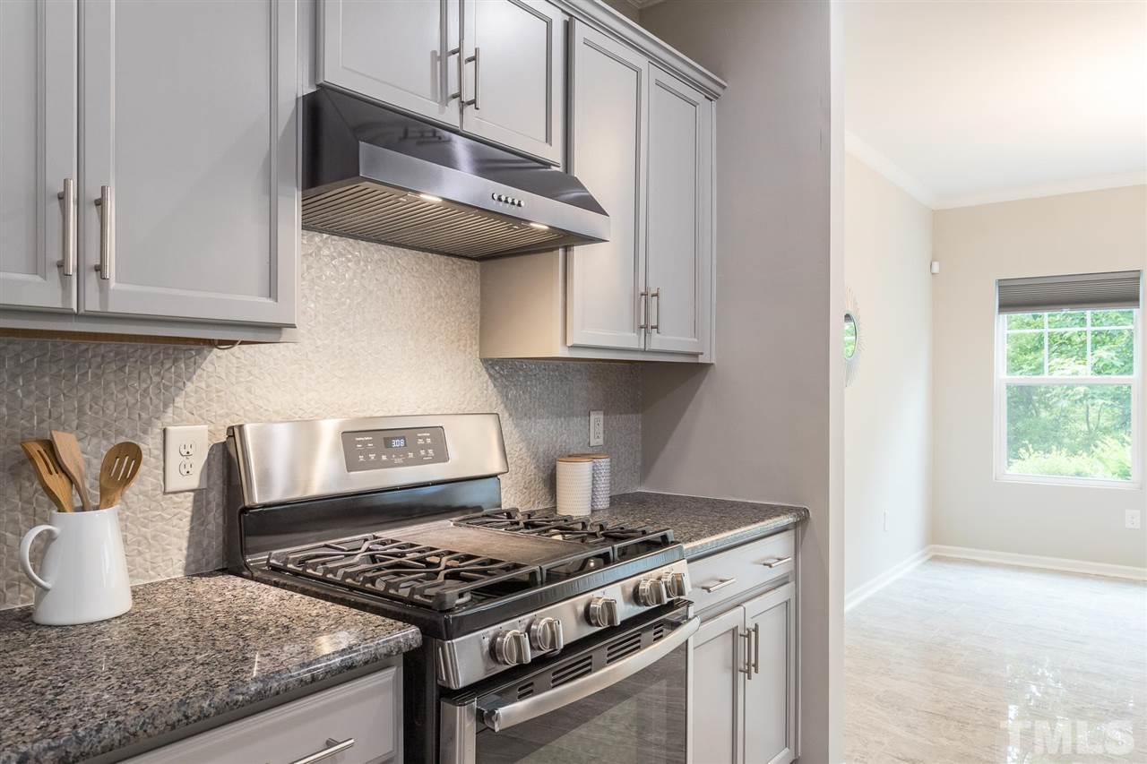 835 Davidson Point Road Cary, NC 27513 - Photo 16 of 30 a stove top oven sitting inside of a kitchen