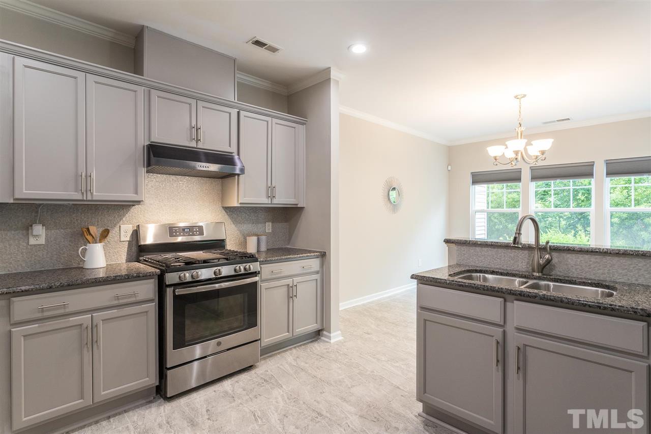 835 Davidson Point Road Cary, NC 27513 - Photo 17 of 30 a kitchen with stainless steel appliances granite countertop a sink stove and cabinets