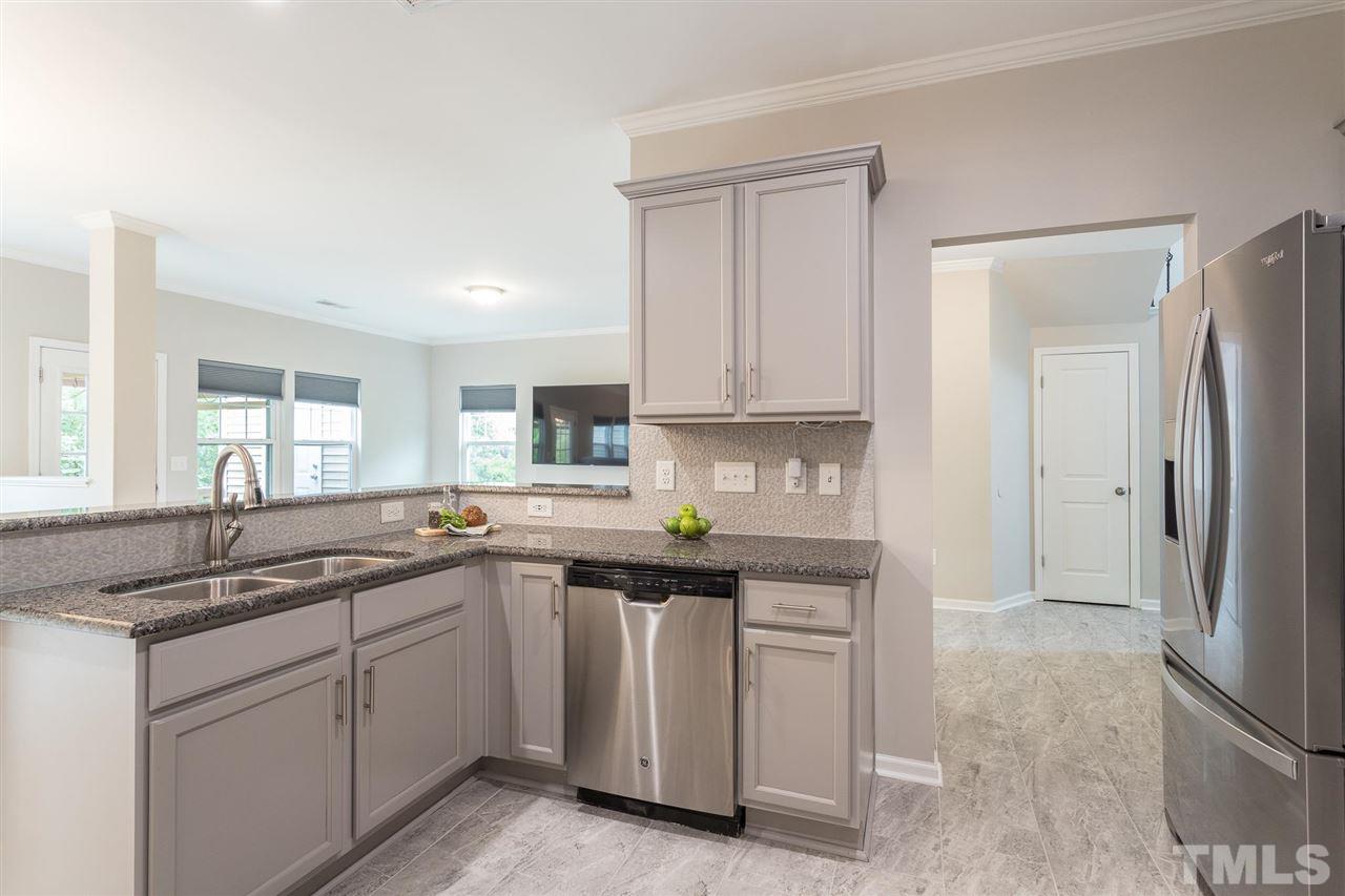 835 Davidson Point Road Cary, NC 27513 - Photo 20 of 30 a kitchen with white cabinets and a sink