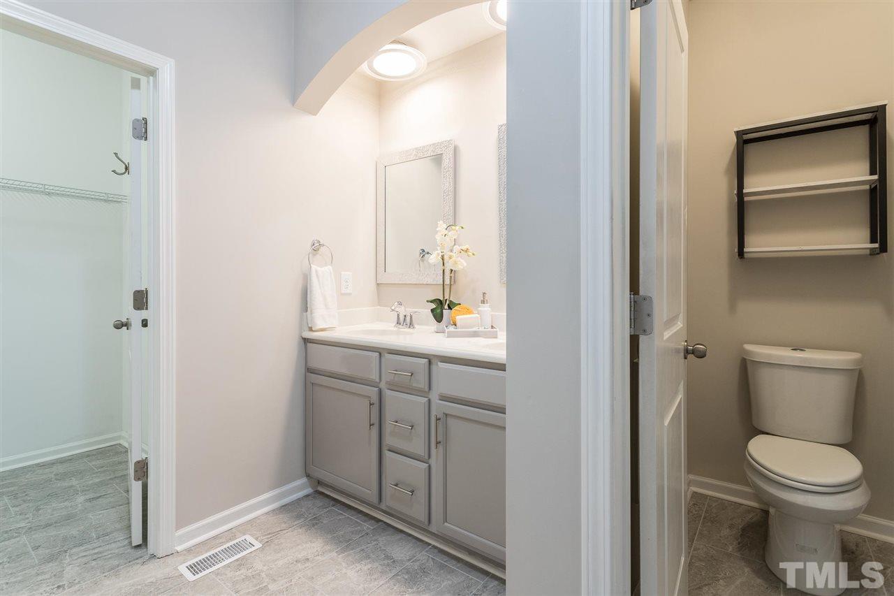 835 Davidson Point Road Cary, NC 27513 - Photo 21 of 30 a bathroom with a granite countertop sink toilet and mirror