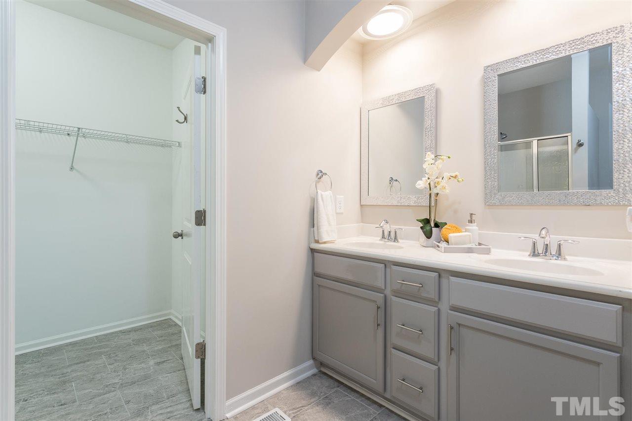 835 Davidson Point Road Cary, NC 27513 - Photo 23 of 30 a bathroom with a double vanity sink and mirror