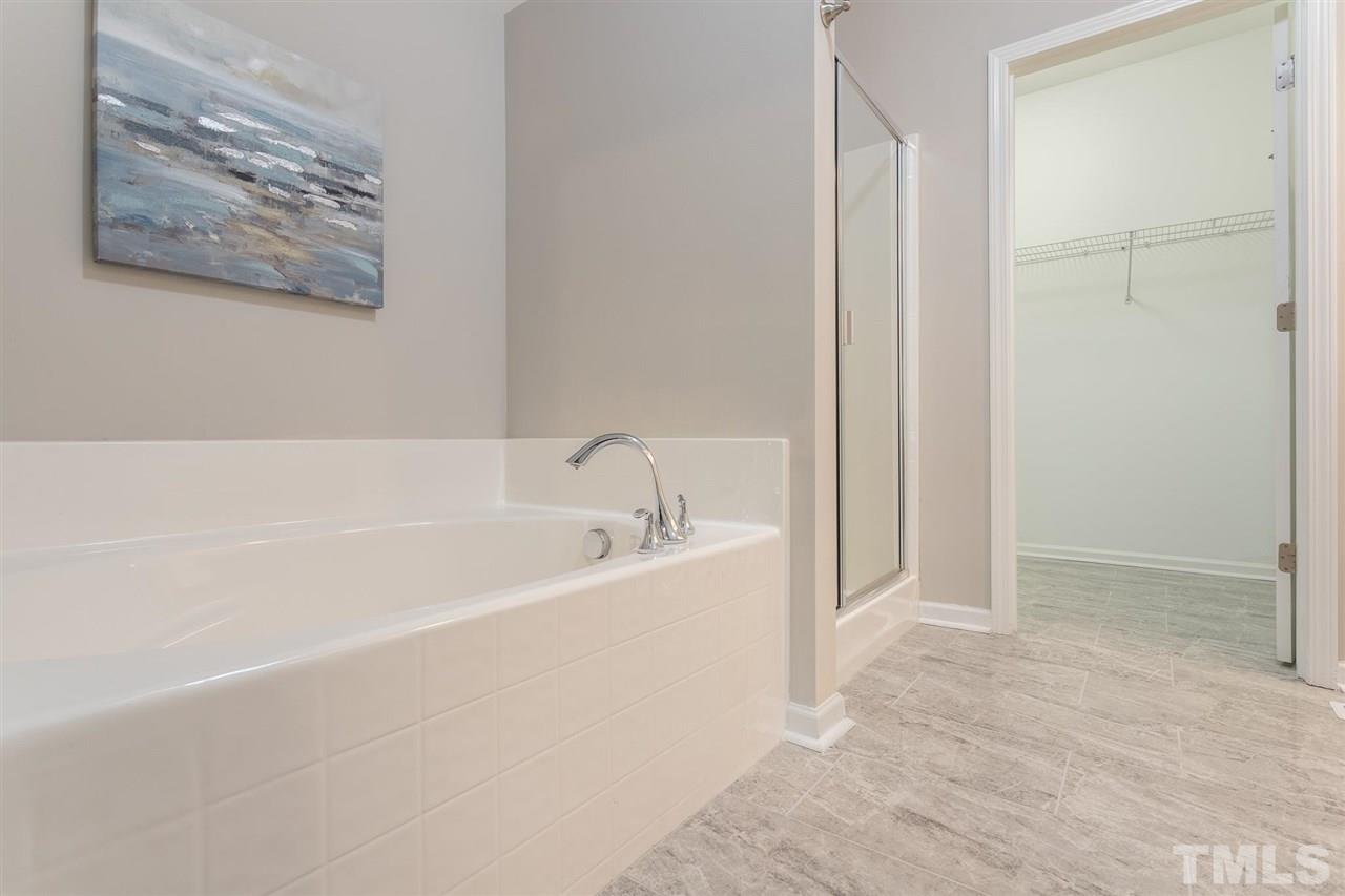 835 Davidson Point Road Cary, NC 27513 - Photo 24 of 30 a white bath tub sitting next to a white sink