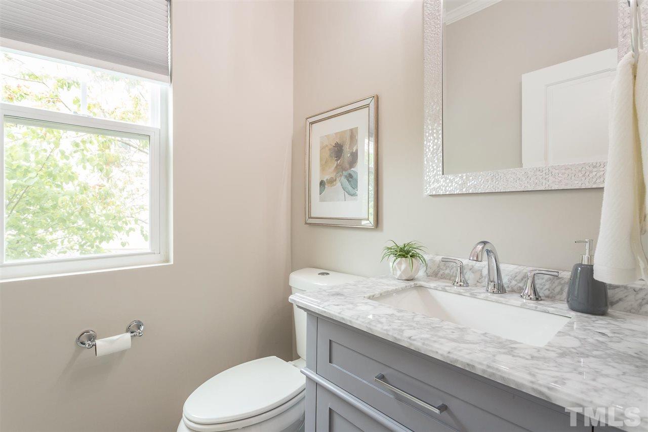 835 Davidson Point Road Cary, NC 27513 - Photo 4 of 30 a bathroom with a granite countertop toilet sink and mirror