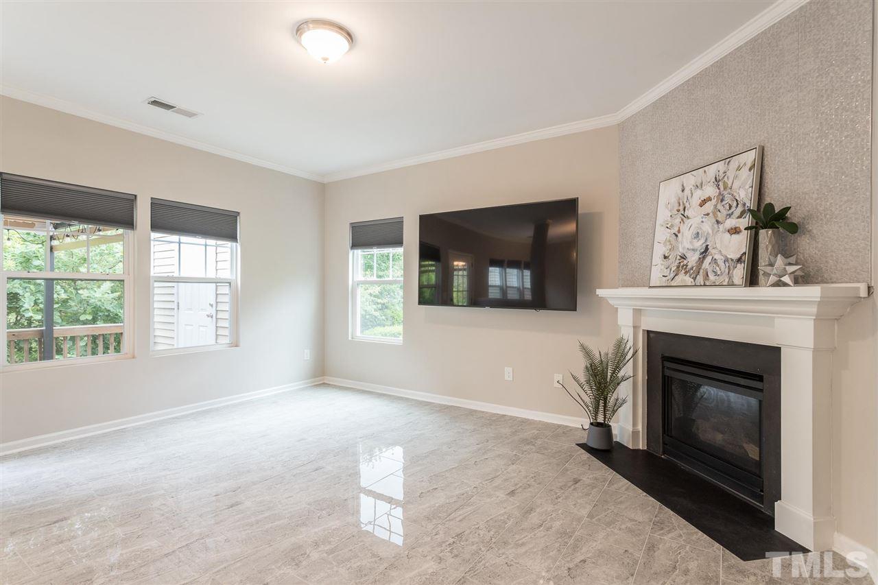 835 Davidson Point Road Cary, NC 27513 - Photo 7 of 30 a living room with furniture and a fireplace