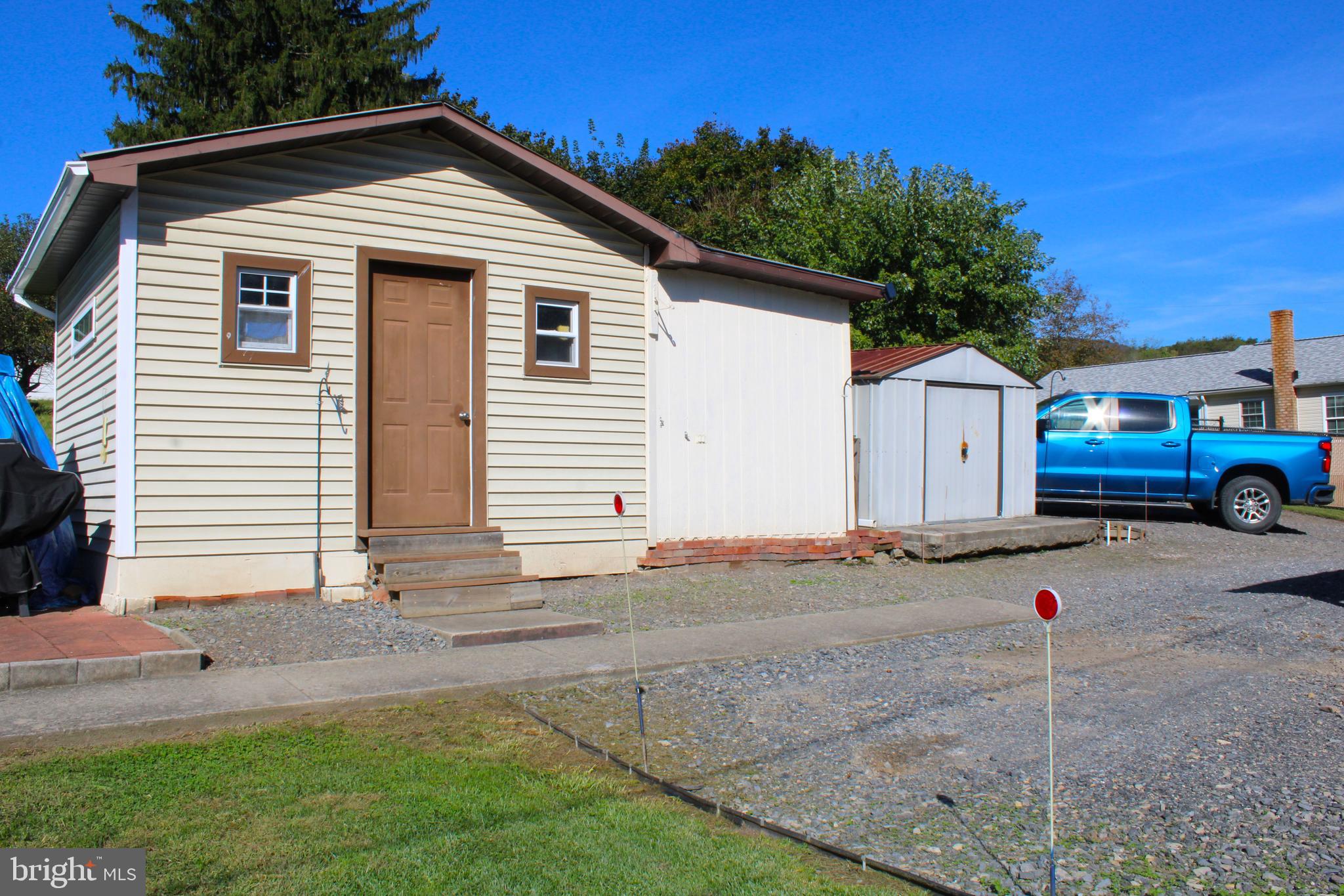 10117 Hummingbird Street Ellerslie, MD 21529 - Photo 18 of 76 a front view of a house with a yard and garage