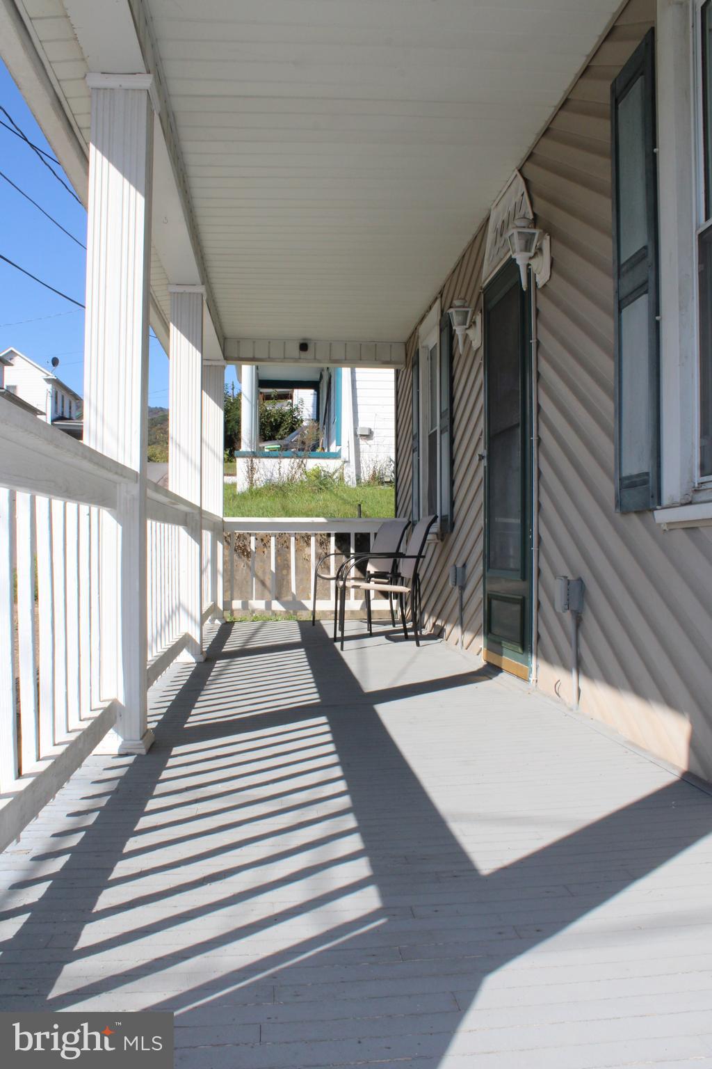 10117 Hummingbird Street Ellerslie, MD 21529 - Photo 25 of 76 a view of a patio with table and chairs with wooden floor and fence
