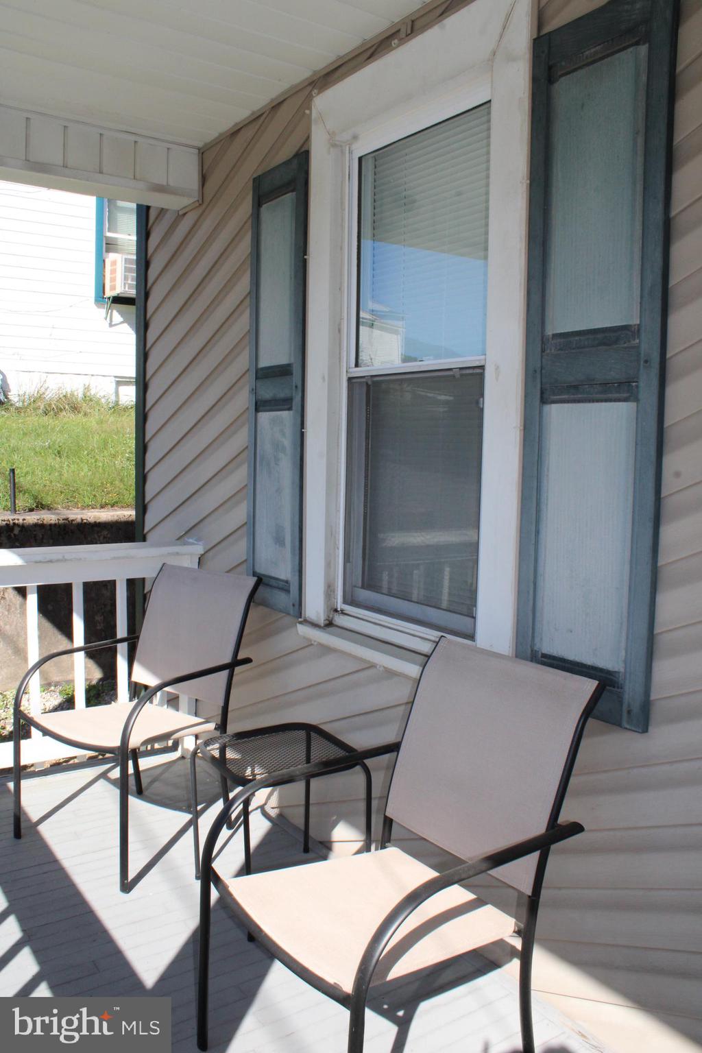 10117 Hummingbird Street Ellerslie, MD 21529 - Photo 27 of 76 a view of a patio with table and chairs with wooden floor and fence