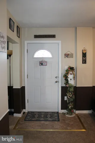 a view of a room with furniture and a chandelier