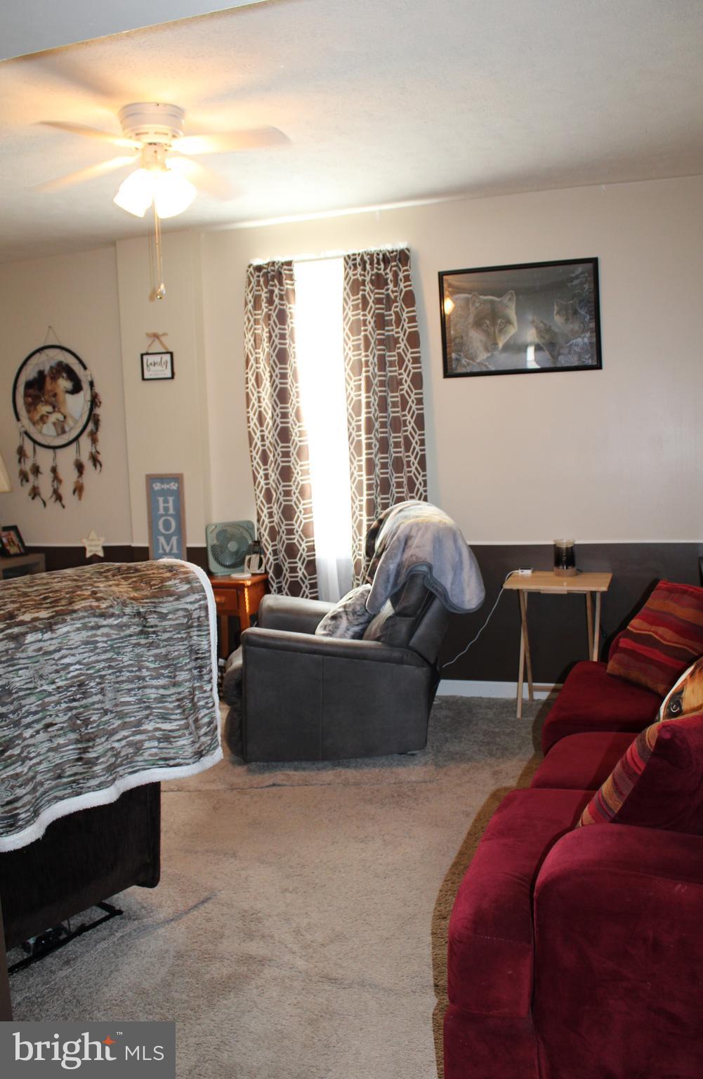 10117 Hummingbird Street Ellerslie, MD 21529 - Photo 31 of 76 a living room with furniture and painting on the wall