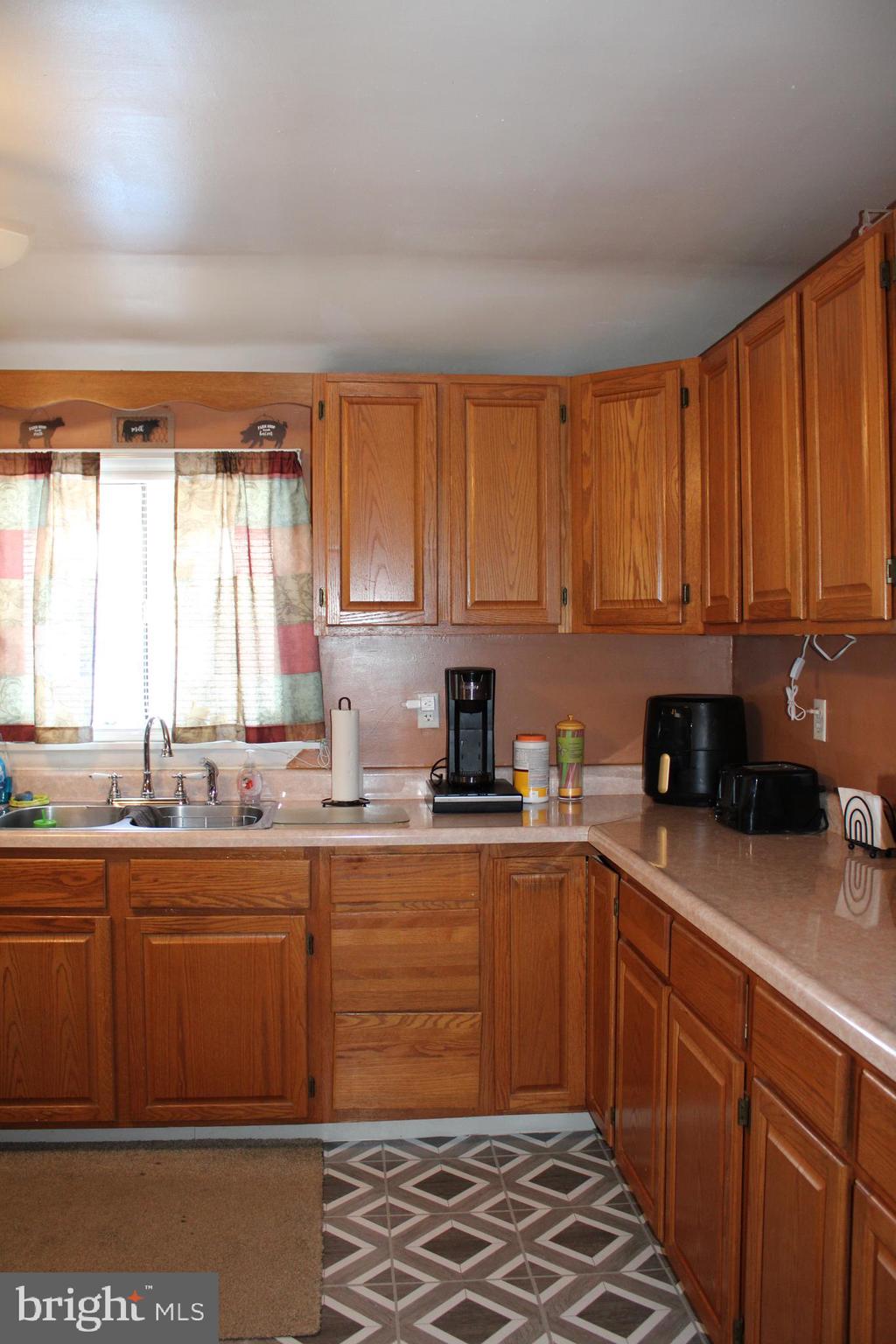 10117 Hummingbird Street Ellerslie, MD 21529 - Photo 46 of 76 a kitchen with stainless steel appliances granite countertop a sink stove and refrigerator