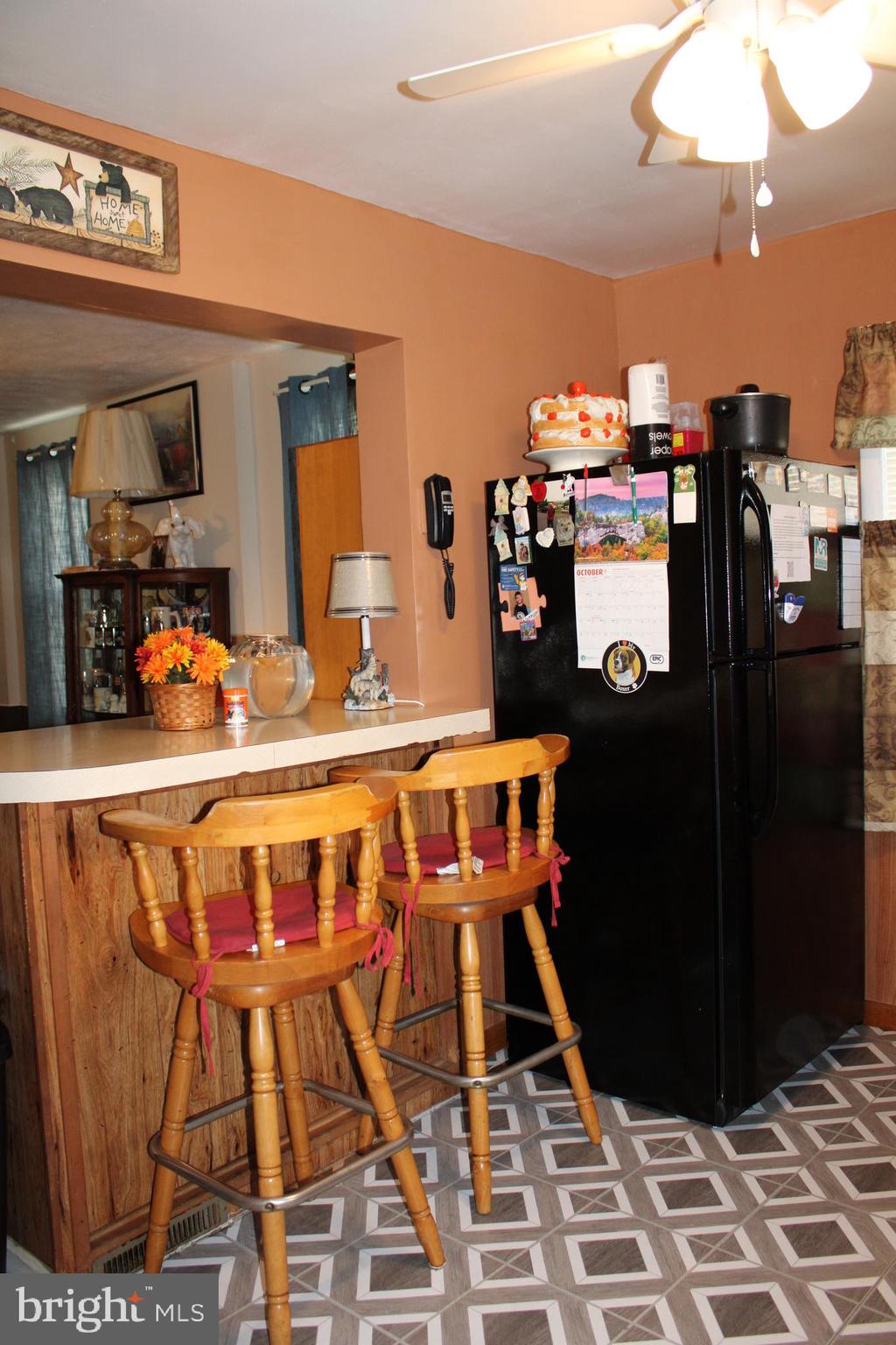 10117 Hummingbird Street Ellerslie, MD 21529 - Photo 48 of 76 a kitchen with stainless steel appliances kitchen island granite countertop a refrigerator and a stove