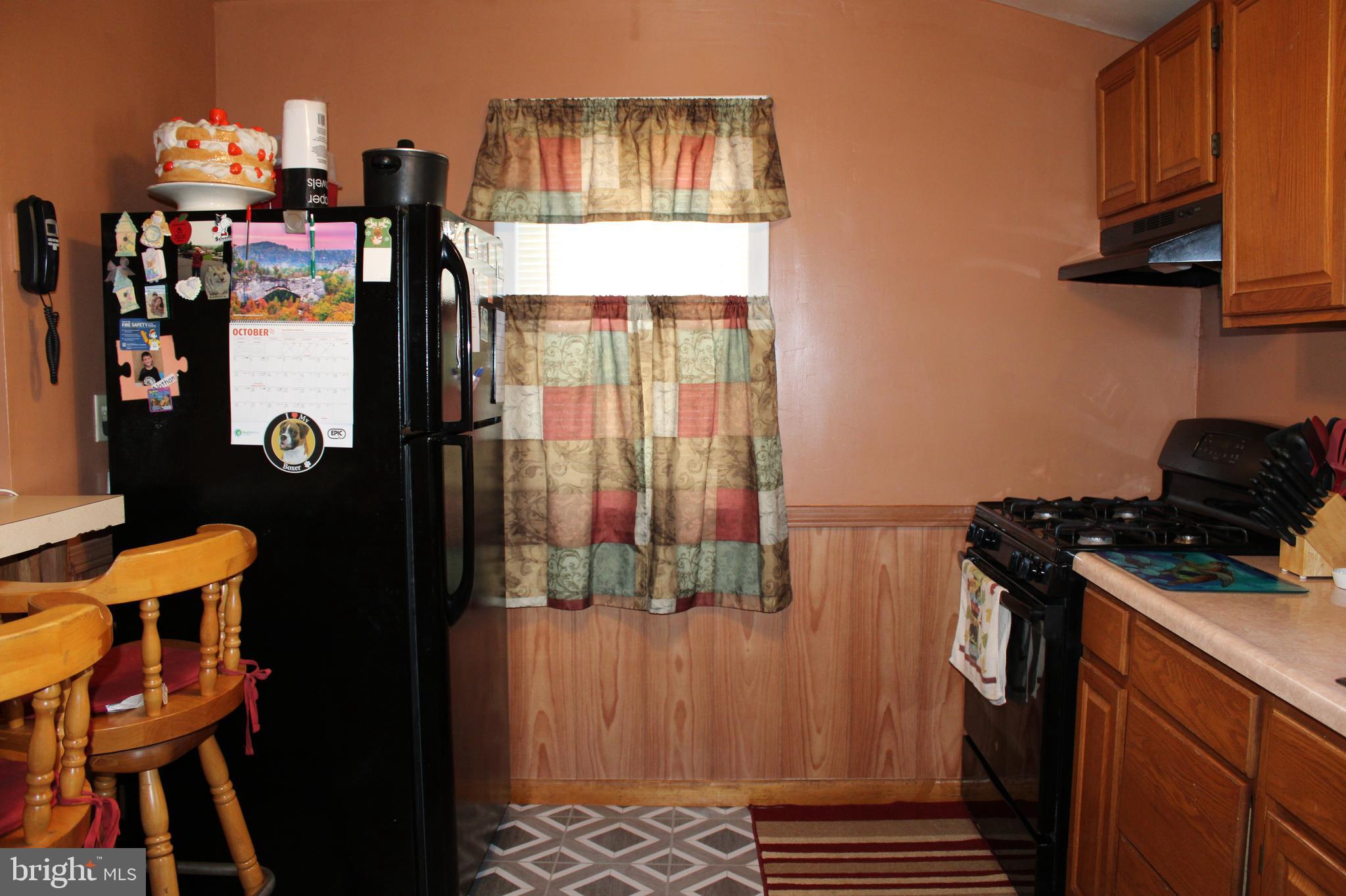 10117 Hummingbird Street Ellerslie, MD 21529 - Photo 49 of 76 a kitchen with a refrigerator and a stove
