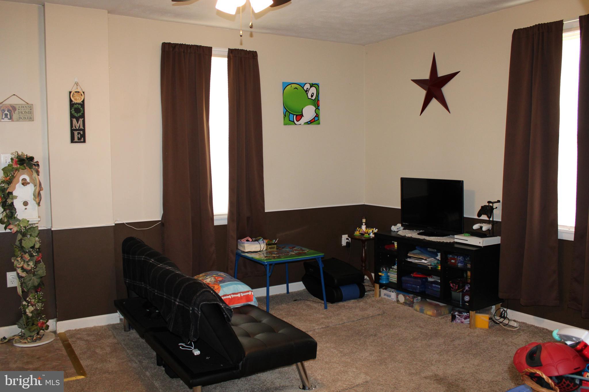 10117 Hummingbird Street Ellerslie, MD 21529 - Photo 53 of 76 a living room with furniture and a flat screen tv