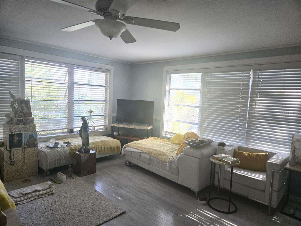 2455 Royal Road DeLand, FL 32724 - Photo 9 of 18 a bedroom with bed couch and window