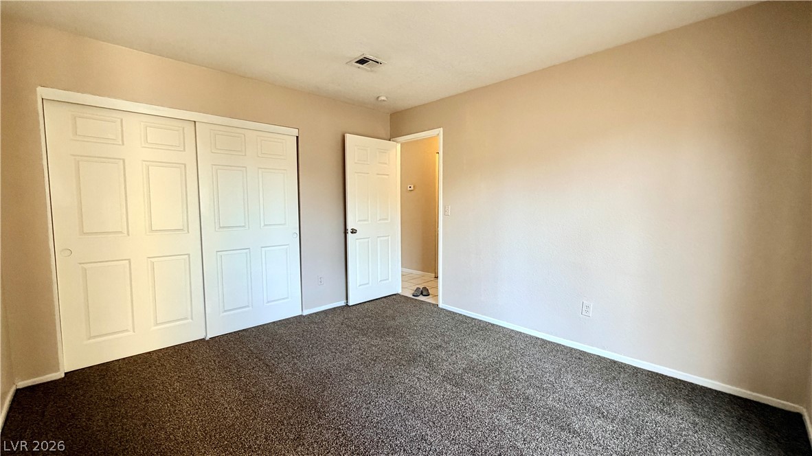 6250 West Flamingo Road, Unit 4 Las Vegas, NV 89103 - Photo 28 of 45 This spacious bedroom offers comfortable living with ample storage and easy access to an adjacent bathroom.